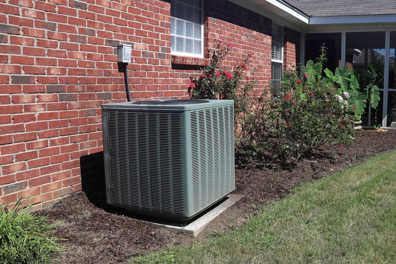 FNB Home HVAC Unit next to modern brick home GettyImages 1164592028
